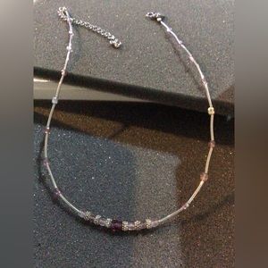 Woman’s purple necklace by lia sophia